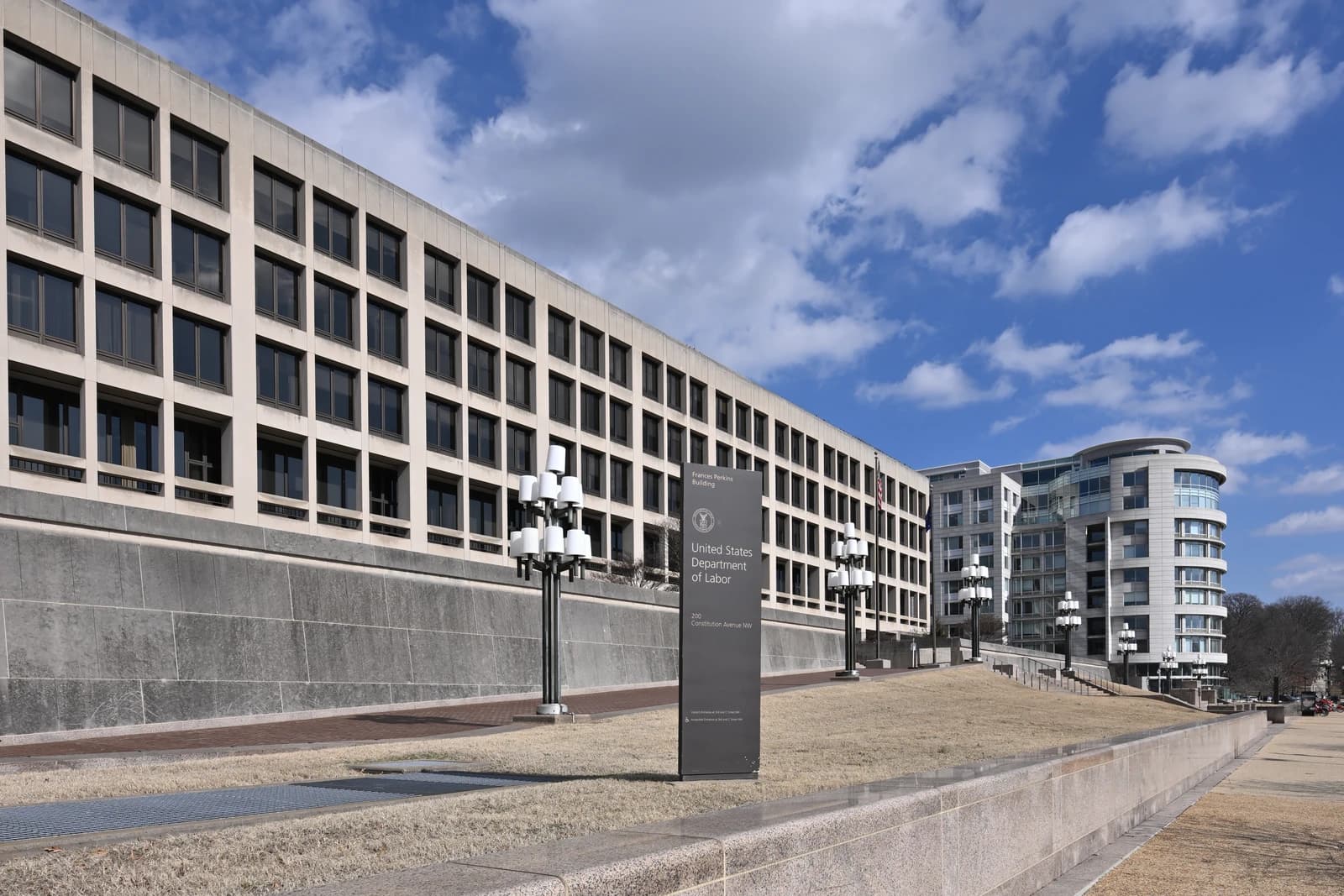 Exterior of the United States Department of Labor building in Washington D.C. under a blue sky.