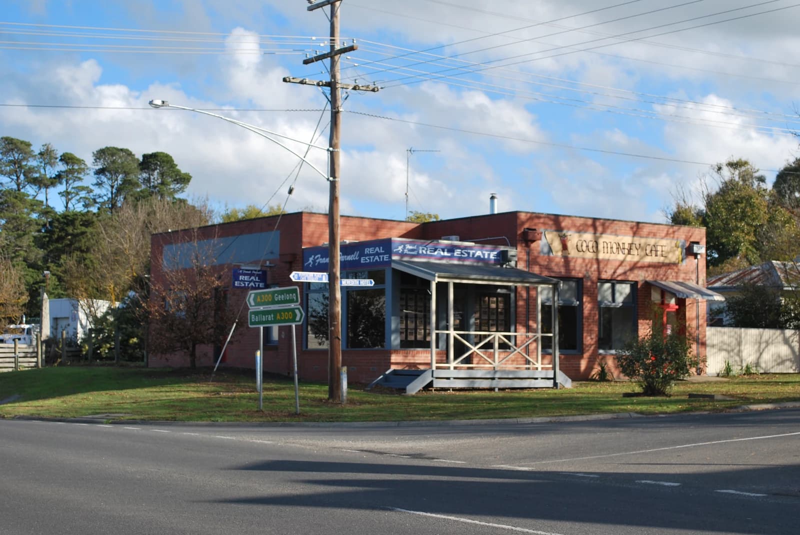 Building housing Meredith Real Estate and Coco Monkey Cafe on a street corner.