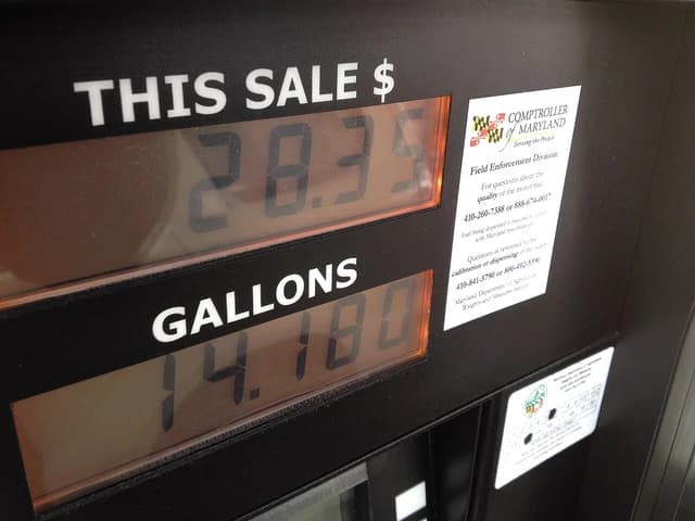 Gas pump display showing a total sale of $28.35 for 14.180 gallons.