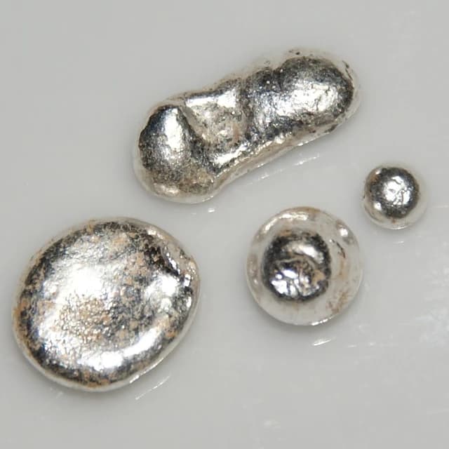 Several pieces of silver, approximately 3 grams in total, on a white background.