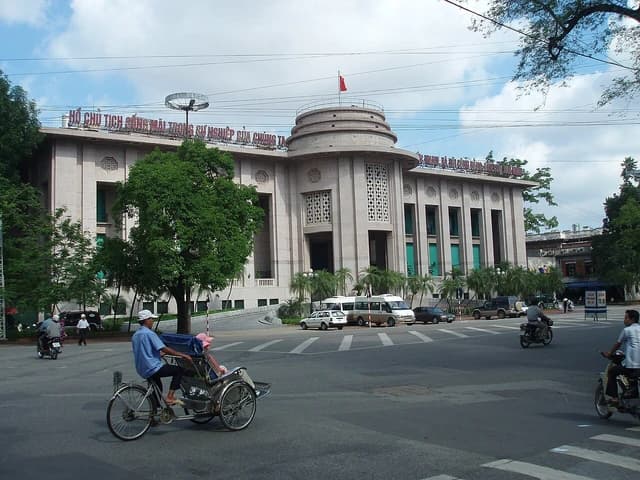 Exterior view of the State Bank of Vietnam headquarters in Hanoi on a cloudy day.