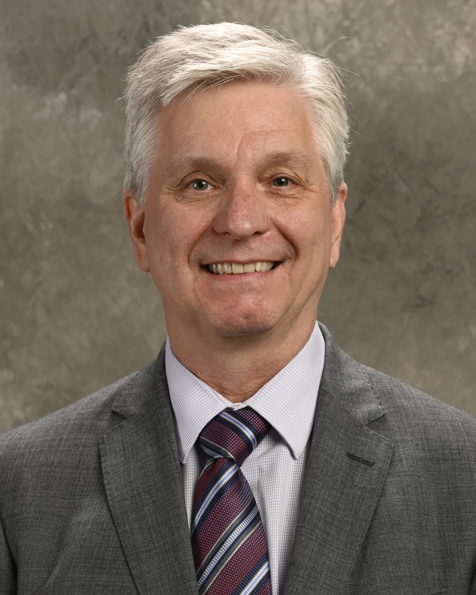 Christopher J. Waller, Federal Reserve Governor, smiling and looking at the camera.