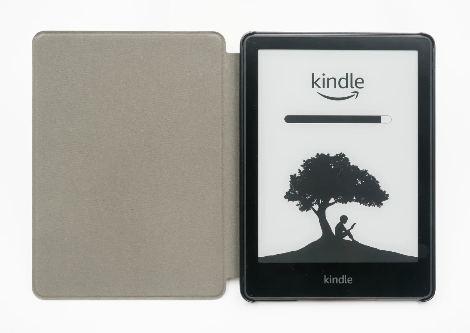 Amazon Kindle Paperwhite e-reader with open gray cover, displaying default screen.