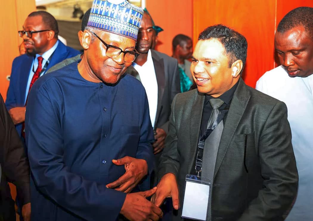 Aliko Dangote, Nigerian businessman, speaking with Zulfi Azad at an event.