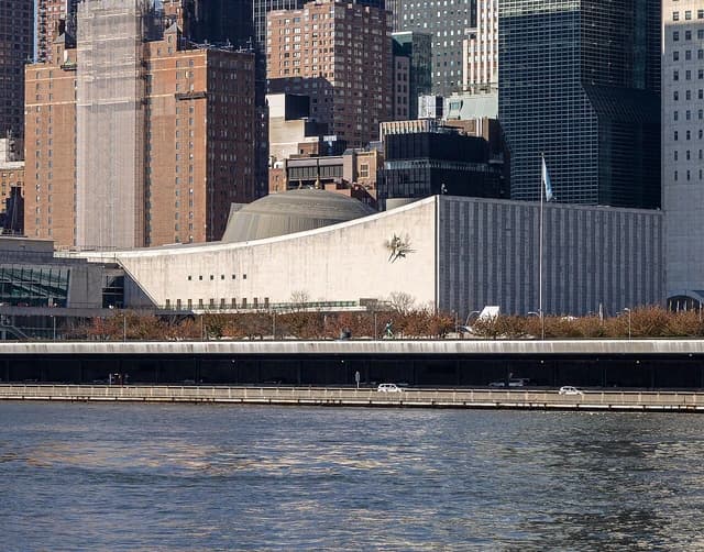 The United Nations General Assembly building and Secretariat building from the East River.
