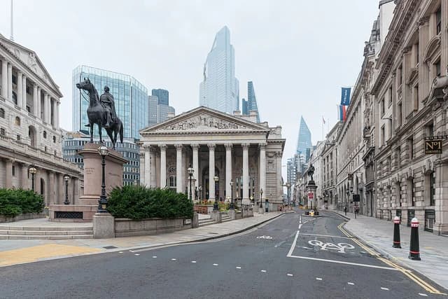 Bank Junction in London with the Royal Exchange building and modern skyscrapers.