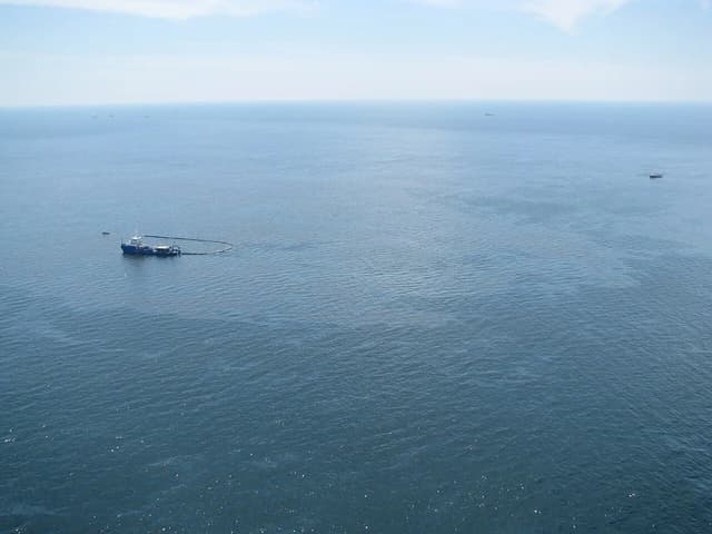 Aerial view of a vessel and oil containment boom on the Gulf of Mexico.