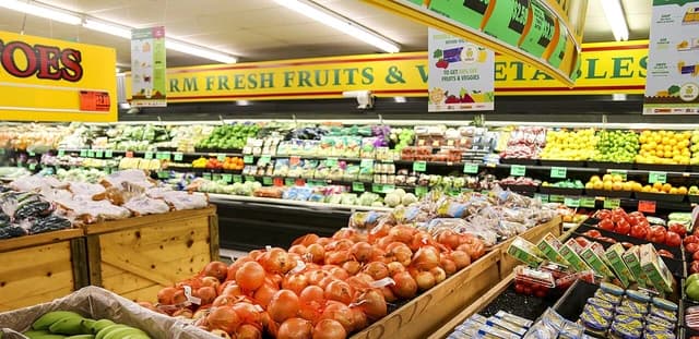 Produce section of a grocery store with various fruits and vegetables.