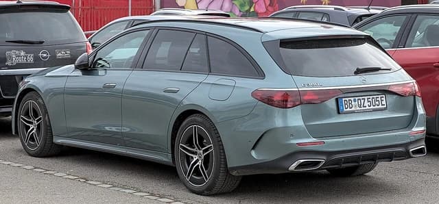 Mercedes-Benz E 300e, a plug-in hybrid electric vehicle, parked on a street.