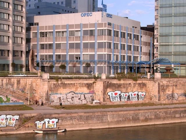 OPEC headquarters building in Vienna, Austria, with graffiti on river walls.