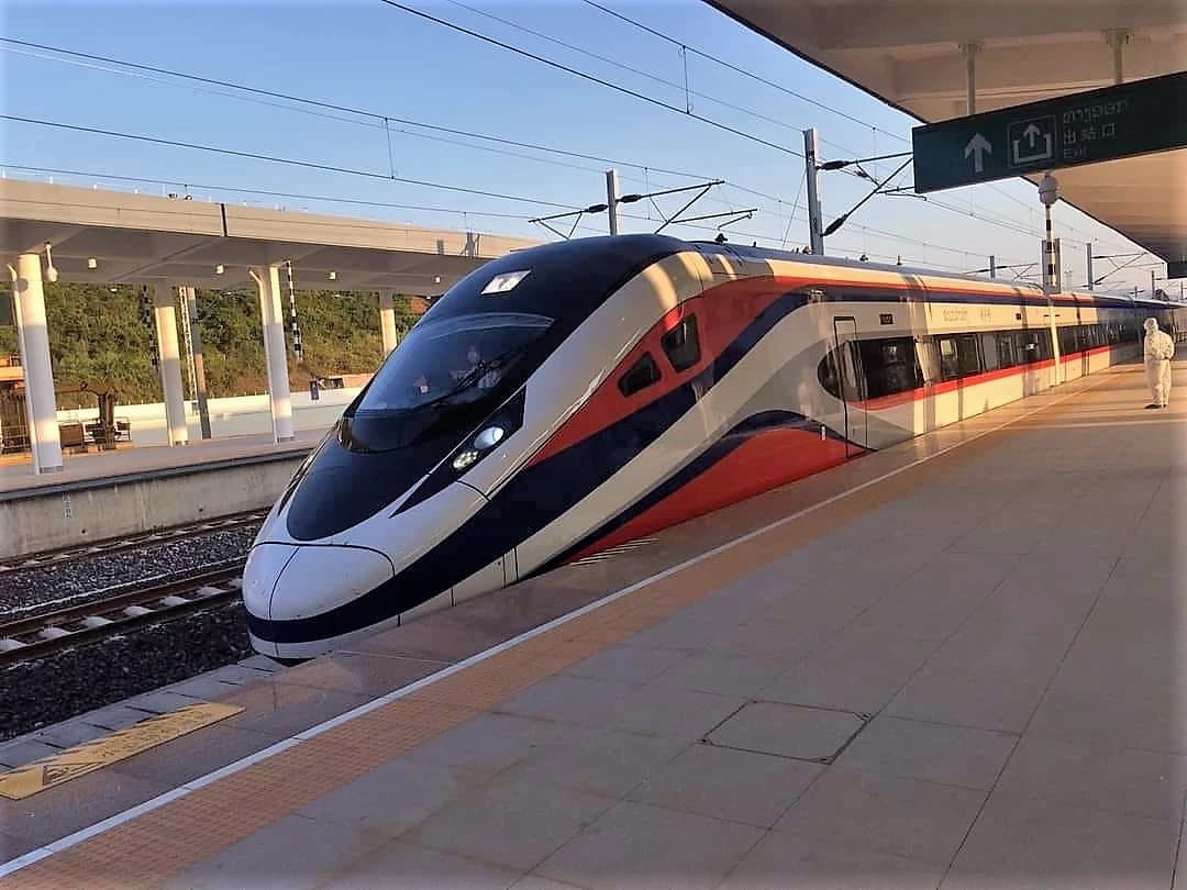 High-speed train of the China-Laos Railway waiting at a station platform.