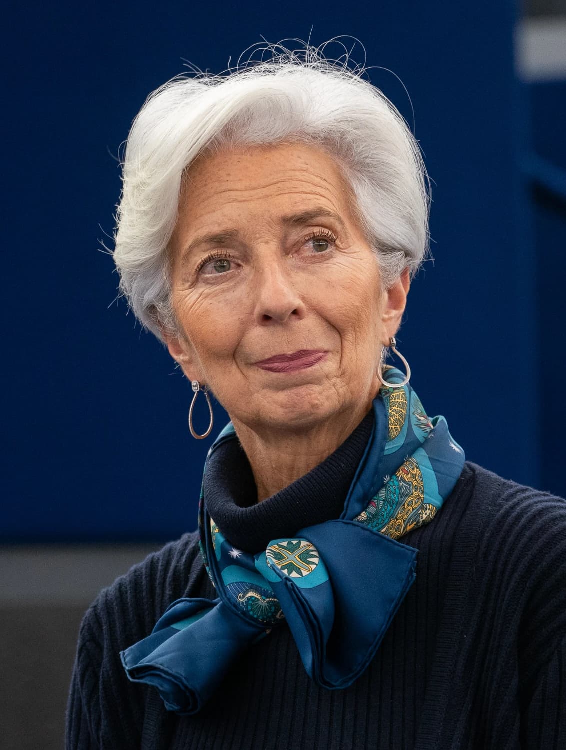 Christine Lagarde, President of the European Central Bank, looking to her right.