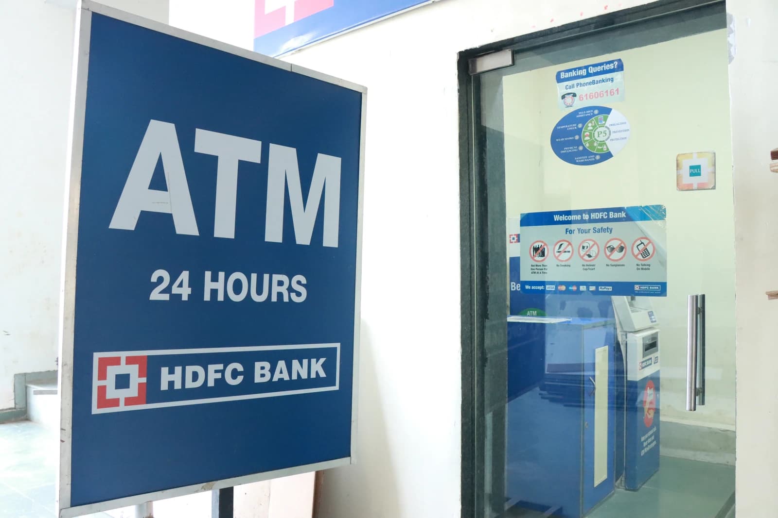 An HDFC Bank ATM sign with the bank's logo and an ATM entrance.