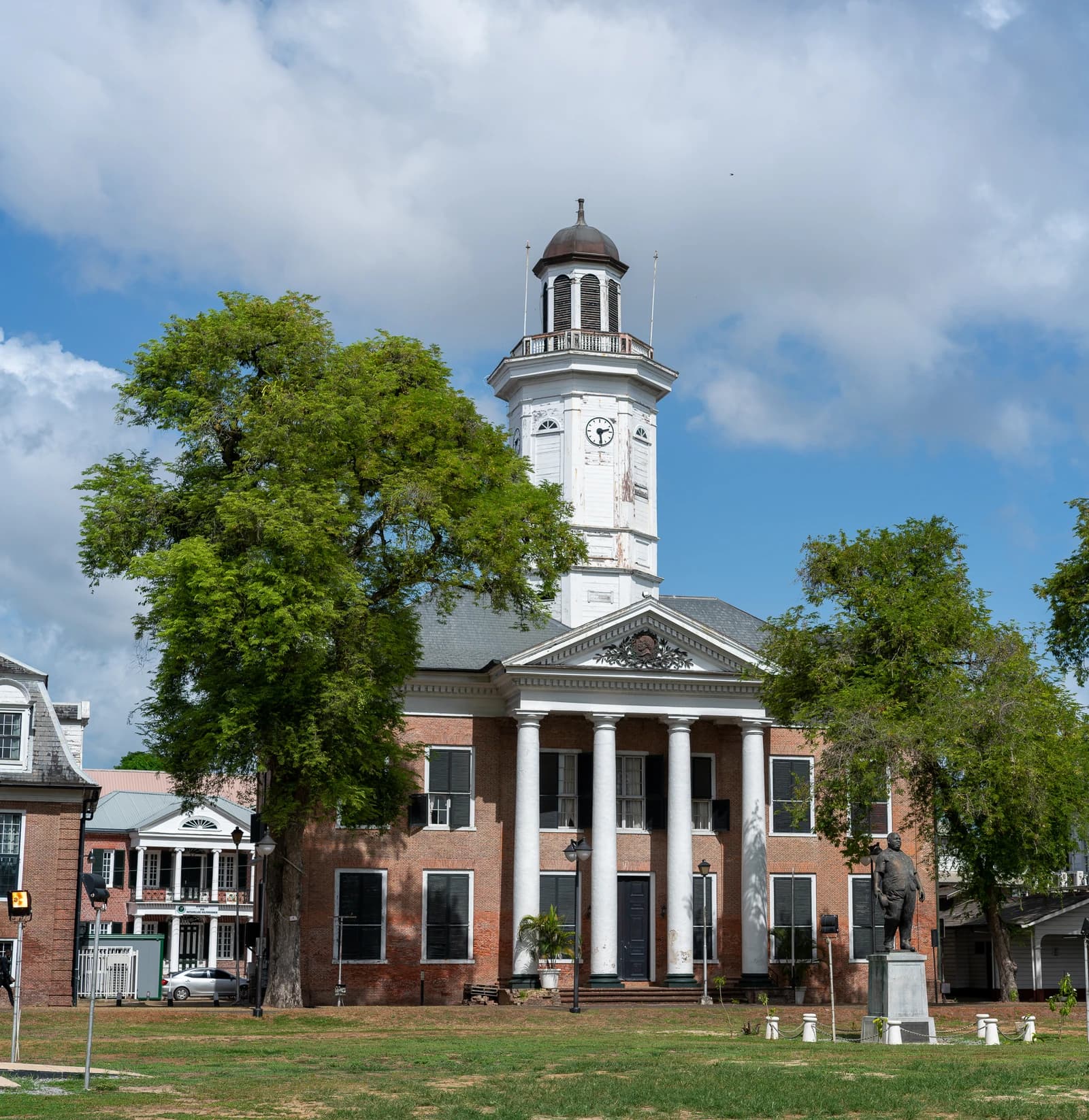 Ministry of Finance building in Paramaribo, Suriname, with a clock tower and columns.