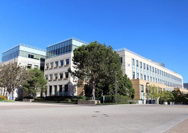 Exterior view of Amgen headquarters, a multi-story building with glass and concrete facades.