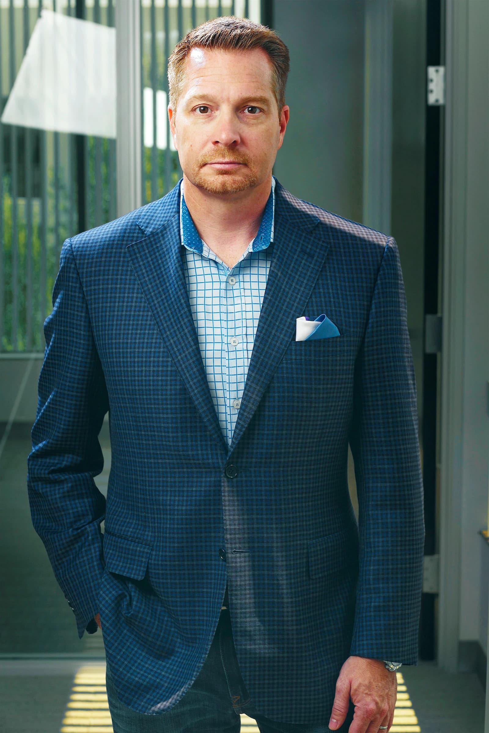 George Kurtz, CEO and co-founder of CrowdStrike Holdings, stands indoors looking towards the camera.