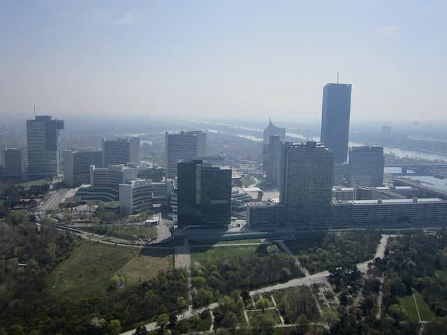 Aerial view of the United Nations Office at Vienna (UNOV) and surrounding modern buildings.