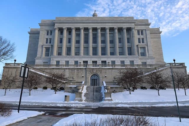 Missouri State Capitol building with snow-covered grounds and classical architecture.