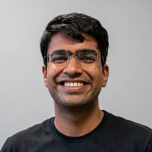 Naman Goyal, in a headshot, smiling for a photograph.