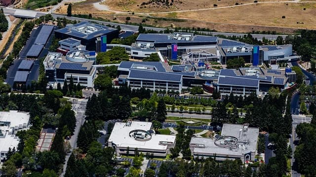 Aerial view of Google Campus in Mountain View, California with buildings and trees.