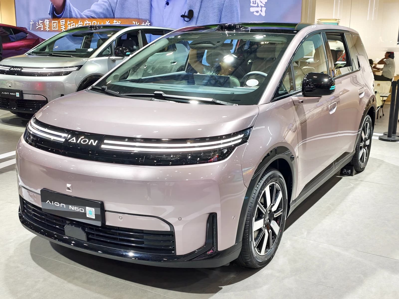 Front view of a 2026 GAC Aion N60 electric MPV displayed indoors.