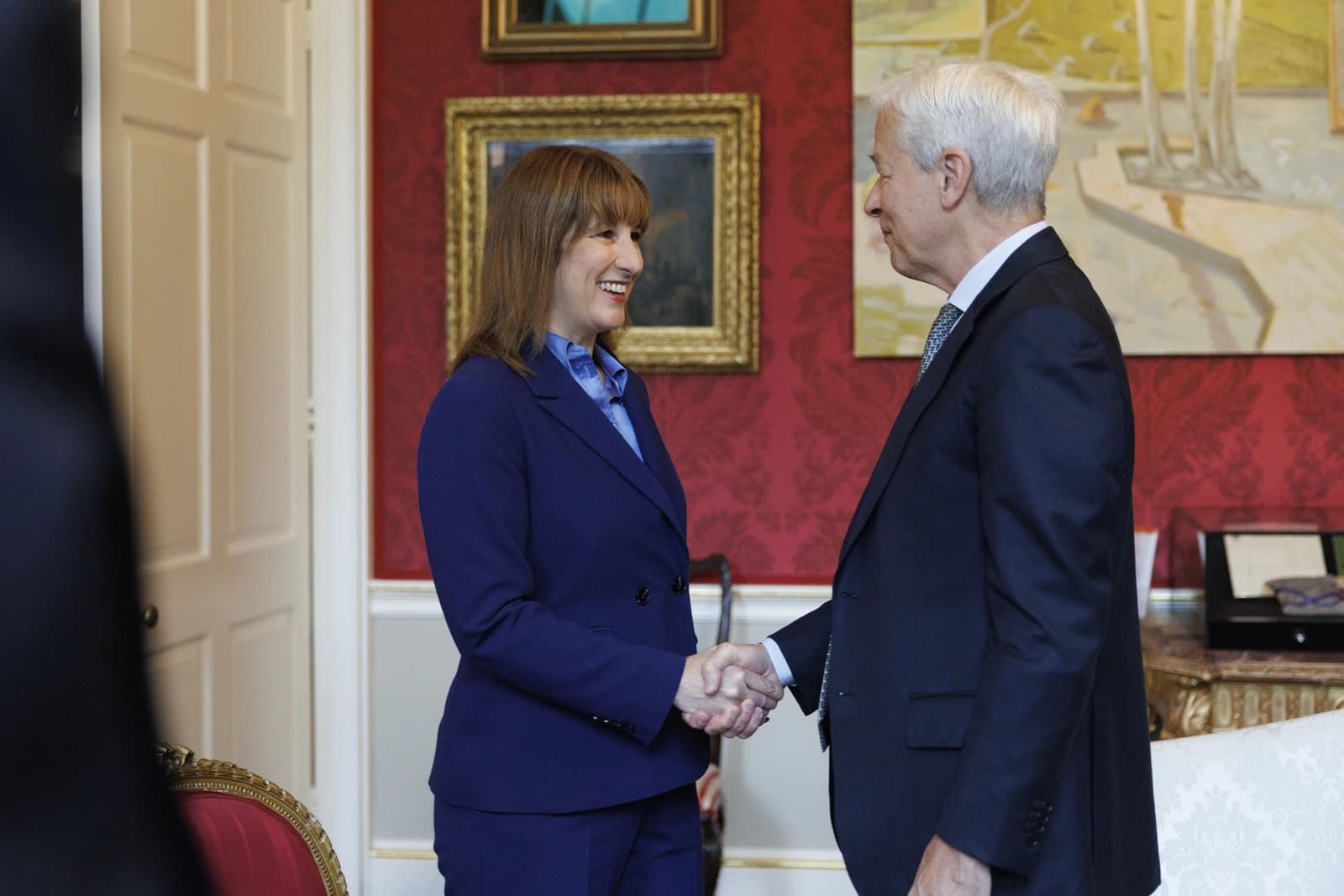 Rachel Reeves, UK Shadow Chancellor, shaking hands with Jamie Dimon, CEO of JPMorgan.