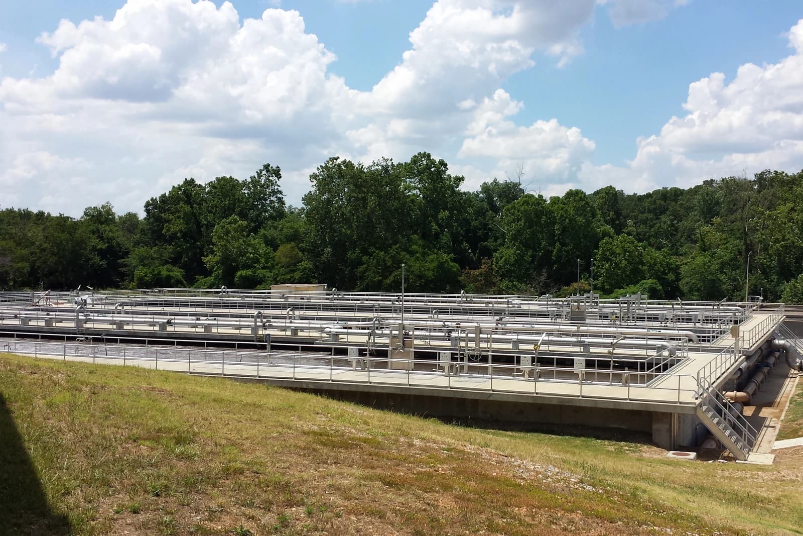 Siloam Springs Wastewater Treatment Plant with treatment tanks and pipes.