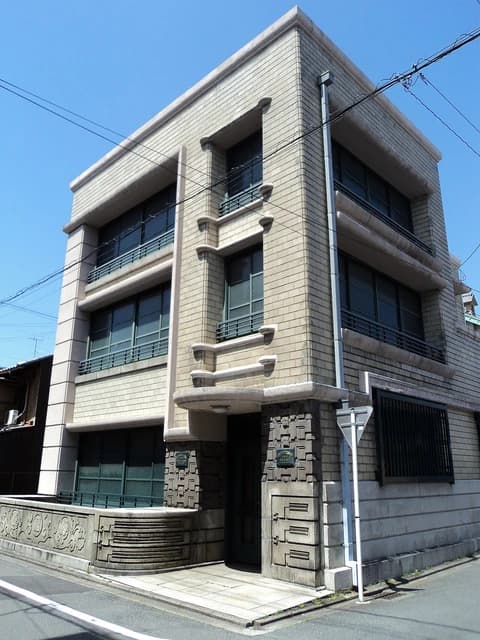 Former Nintendo headquarters building in Kyoto, Japan, under a clear blue sky.