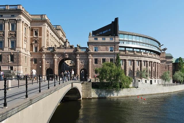 Parliament House of Sweden, Riksdagshuset, viewed across a bridge and water.