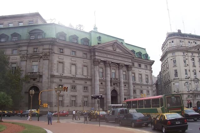 Banco de la Nación Argentina building exterior with traffic on a city street.