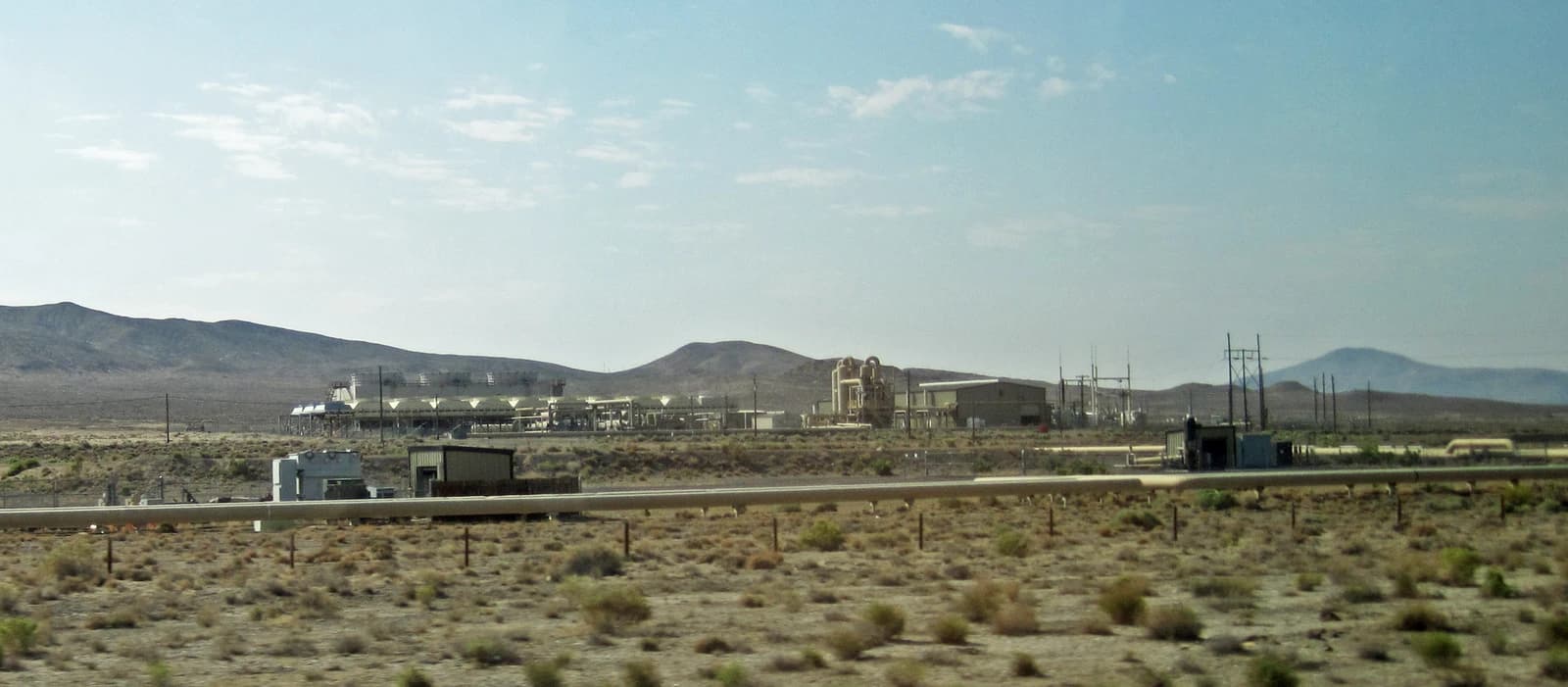 Geothermal power plant at Brady's Hot Springs, Nevada, with desert landscape and mountains.