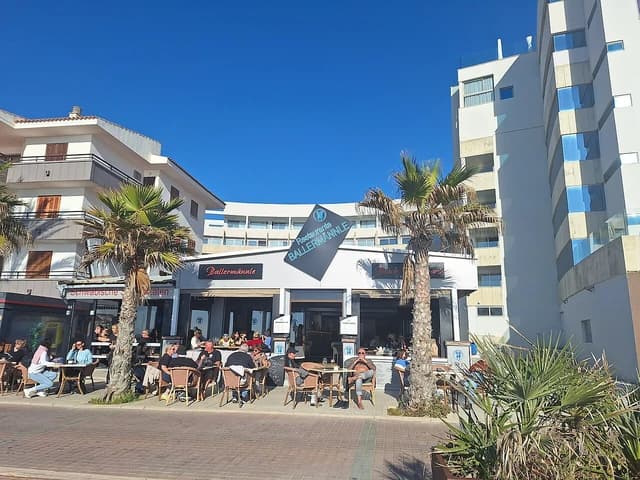 Diners seated at outdoor tables in front of the Ballermännle restaurant in Mallorca.