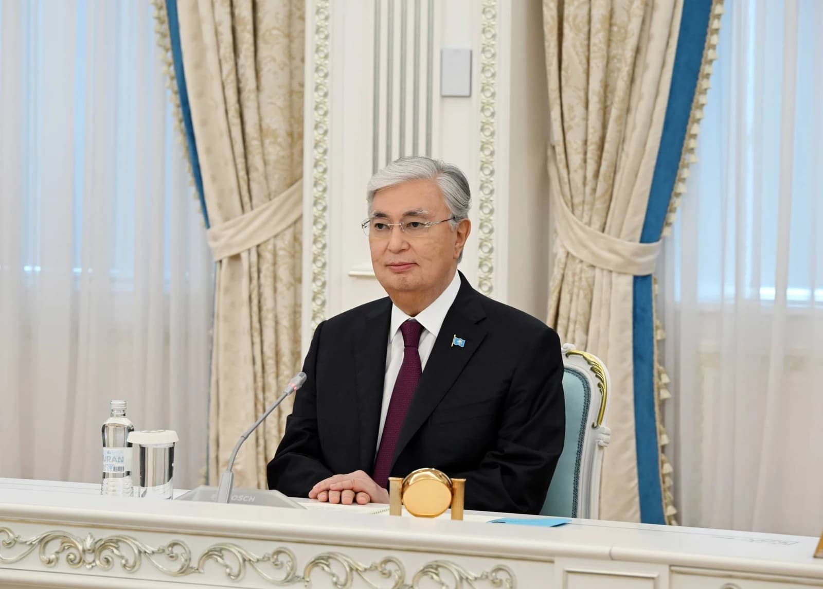 Kassym-Jomart Tokayev, President of Kazakhstan, seated at a formal meeting.