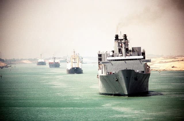 The rapid-response vehicle cargo ship USNS Bellatrix transits the Suez Canal with three commercial tankers.