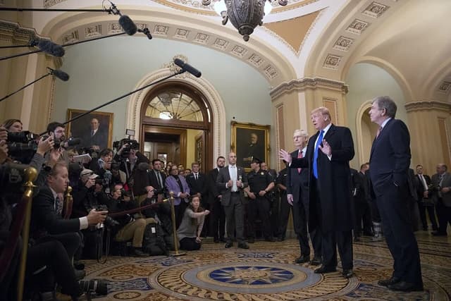 Donald Trump, President of the United States, speaks to reporters at the U.S. Capitol.