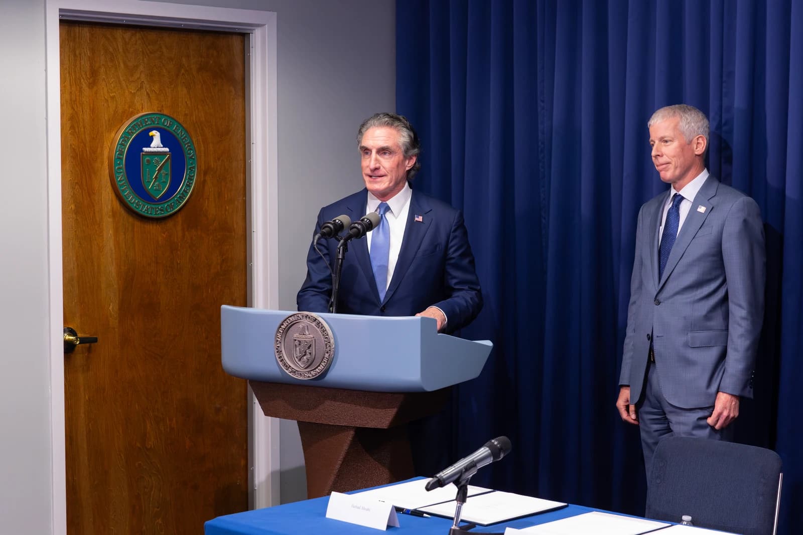 Official from JERA company of Japan speaking at a podium at the U.S. Department of Energy.