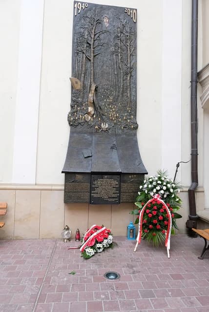Smolensk plane crash memorial with wreaths honoring President Lech Kaczynski and victims.