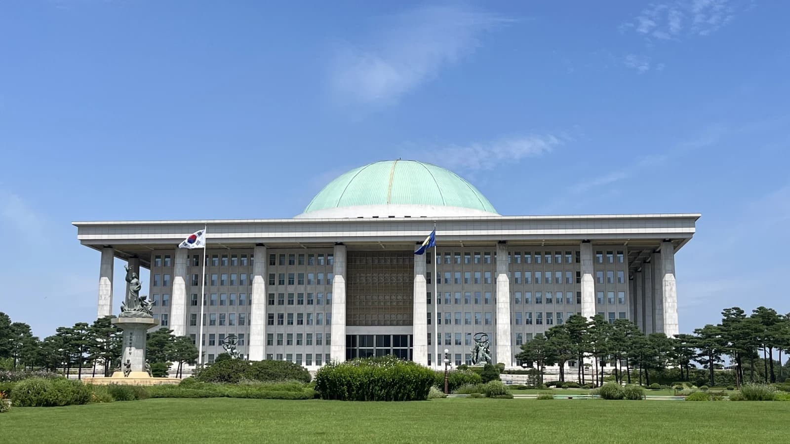National Assembly building in Seoul, South Korea, with a green dome and flag flying.