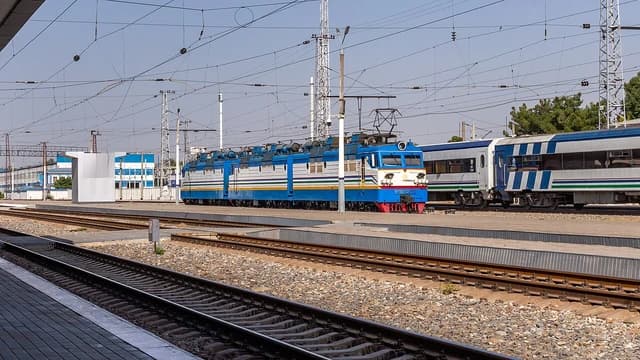 VL80s-2672 electric locomotive parked on tracks at Tashkent-Passenger railway station.