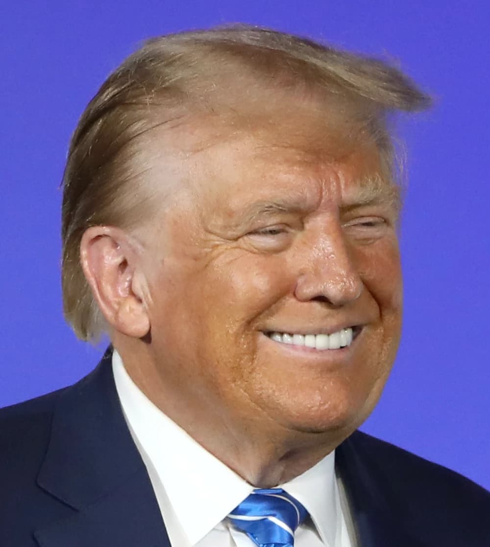 Donald Trump, former U.S. President, smiling at an event.