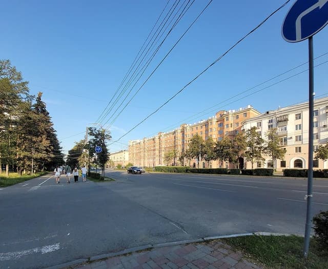 Street view of Lenina Prospekt in Chelyabinsk, Russia, showing residential buildings and a road.