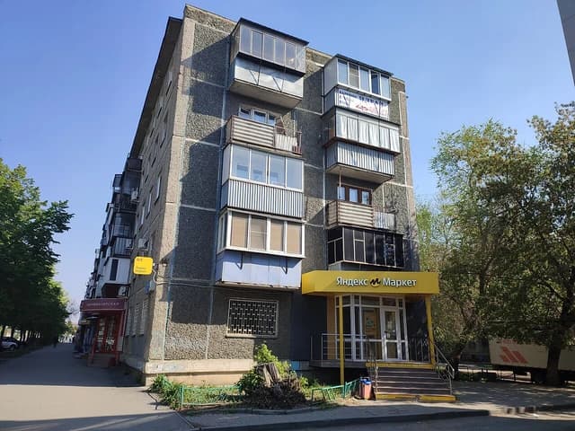 Apartment building with a ground-floor shop entrance on Kirova Street, Chelyabinsk.