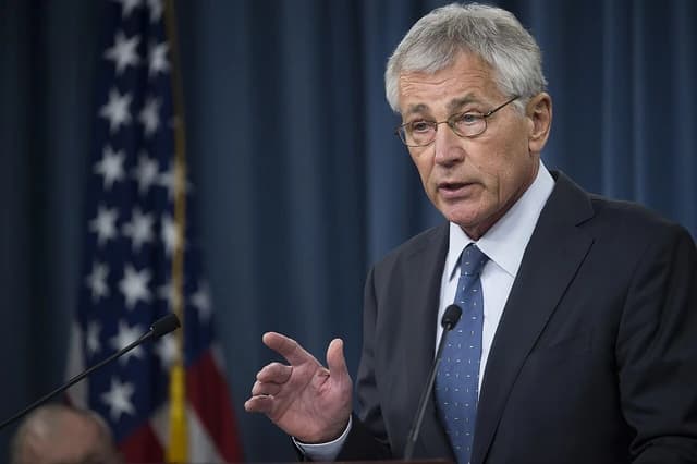 Chuck Hagel, then-Defense Secretary, speaking at a podium with an American flag behind him.
