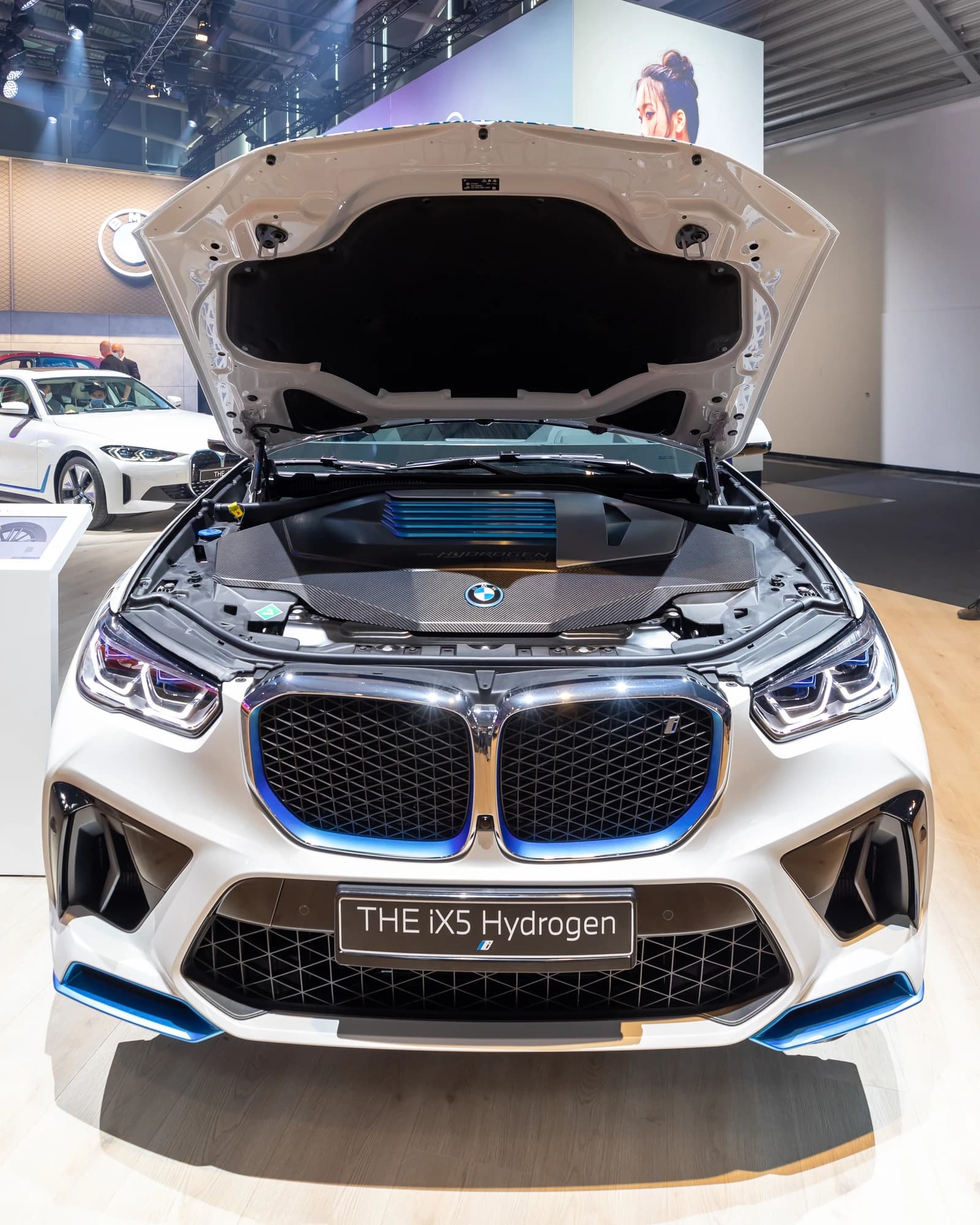 White BMW iX5 Hydrogen car with its hood open on display at the IAA 2021 in Munich.