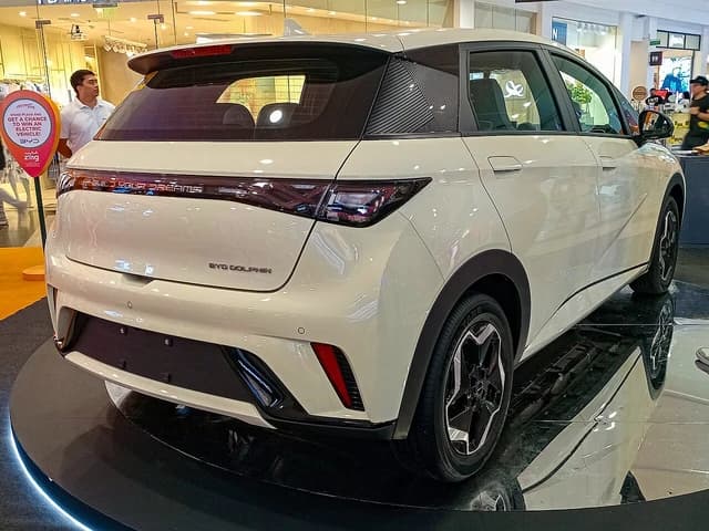 2024 BYD Dolphin EV in Cream White on display, rear right view.