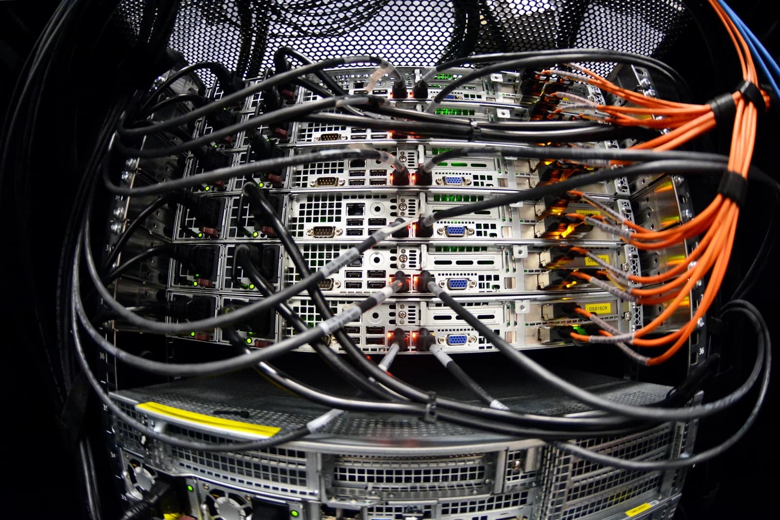 Close-up of server racks with numerous cables connected at a data center.
