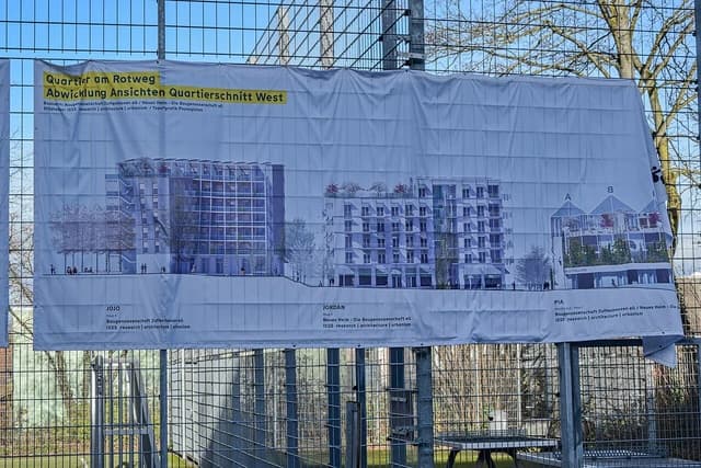 Architectural renderings for new housing development Quartier am Rotweg in Stuttgart-Rot displayed on a banner.