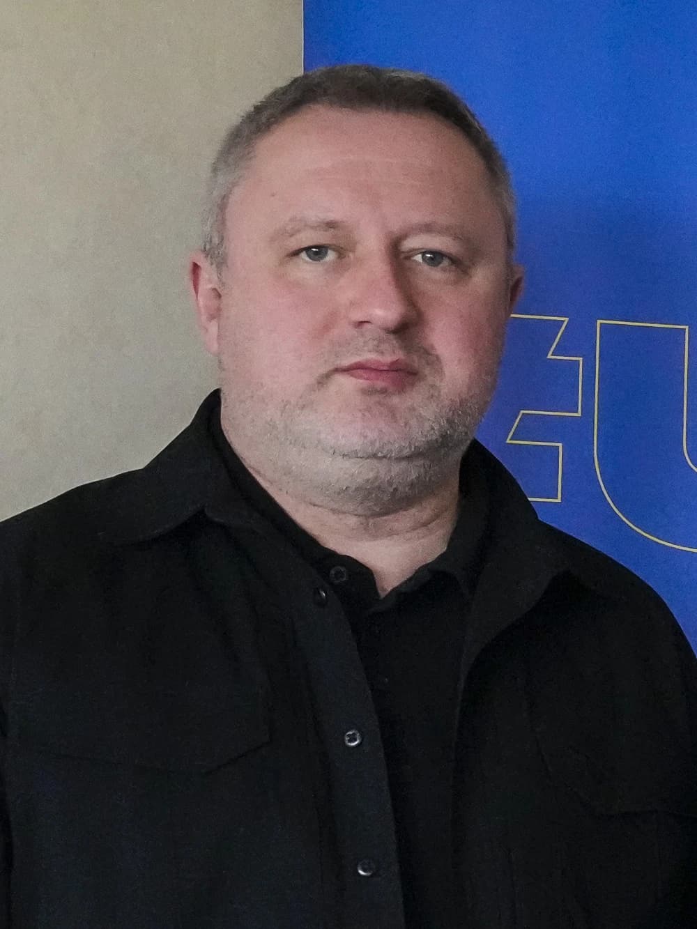 Andriy Kostin, Prosecutor General of Ukraine, standing indoors in front of a backdrop.