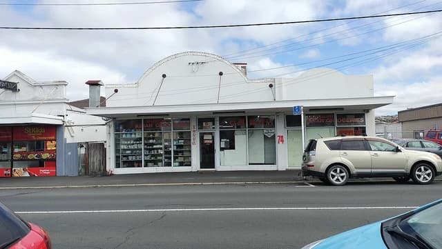 An Asian grocery store with a white facade and large windows showing products inside.