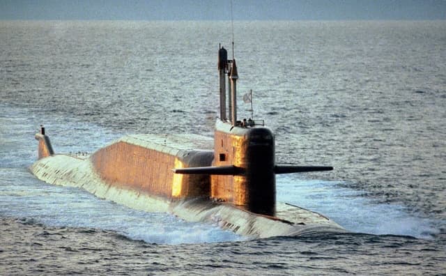 Russian Delta IV class ballistic missile submarine sailing through choppy waters.